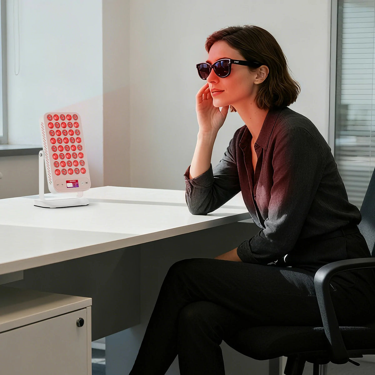 Person using the RTL40A portable red light therapy panel