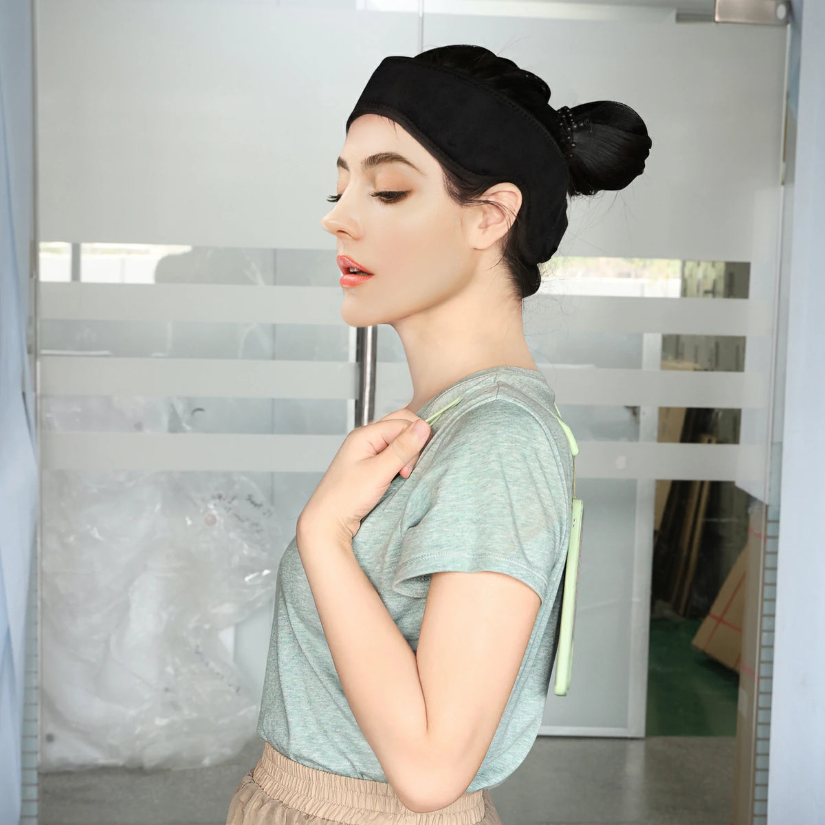 Person using the TLB48 red light therapy head wrap