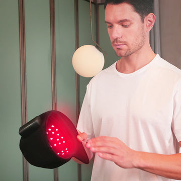 Person using the TLH150WP-A red light therapy cap